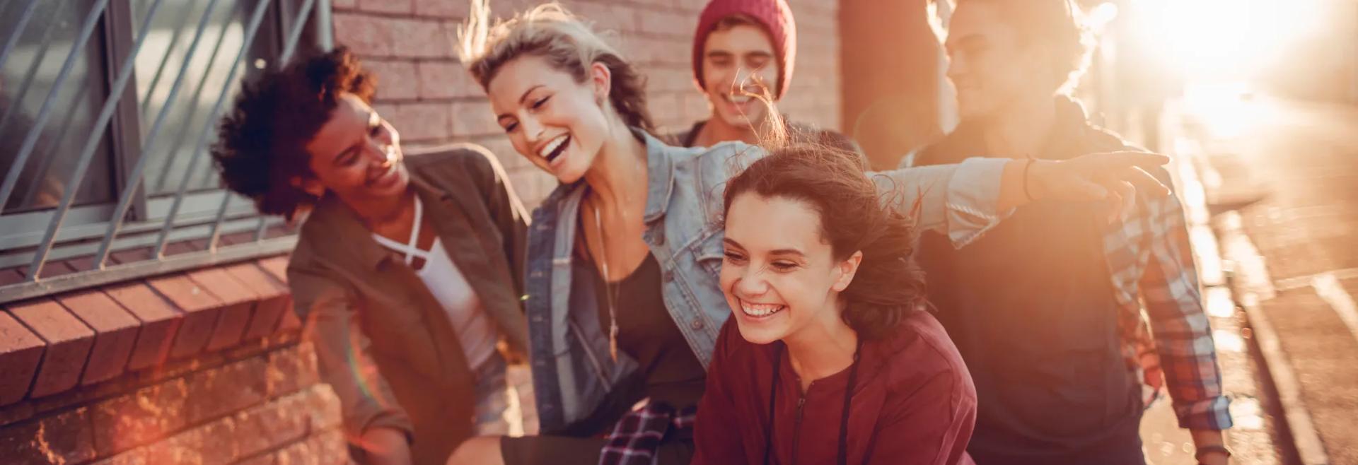 Close up of friends having fun with a shopping cart