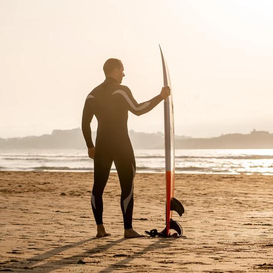 Sprachaufenthalt Spanien, Surfer am Strand bei Sonnenuntergang